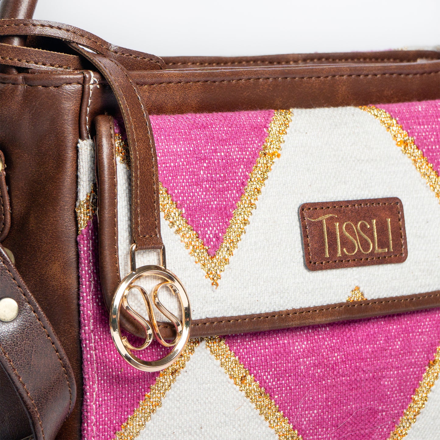 Fuchsia Fusion Hand Bag | Handwoven pink and white geometric design with golden accents for a vibrant look