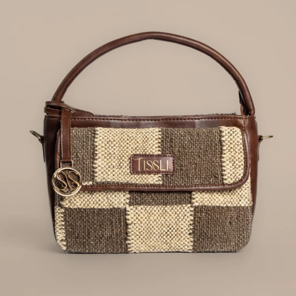 Tissli handwoven checkerboard rug sling bag with brown and cream "Cotton Panja" weave and leather handle.