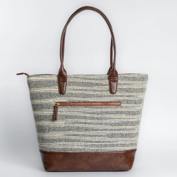 Tissli charcoal and cream handwoven rug tote inspired by the monochromatic stone stripes of Qutub Minar.