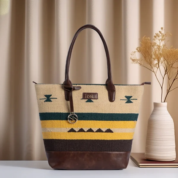 Technical infographic of Tissli Tribal Earth handwoven shuttle rug tote with 44cm width and 14-inch laptop capacity.