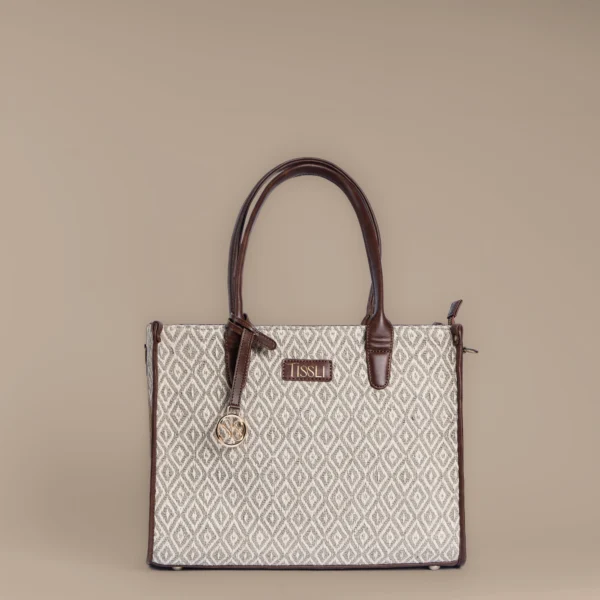 Structured taupe and cream handwoven rug tote with diamond trellis pattern and brown leather handles by Tissli.